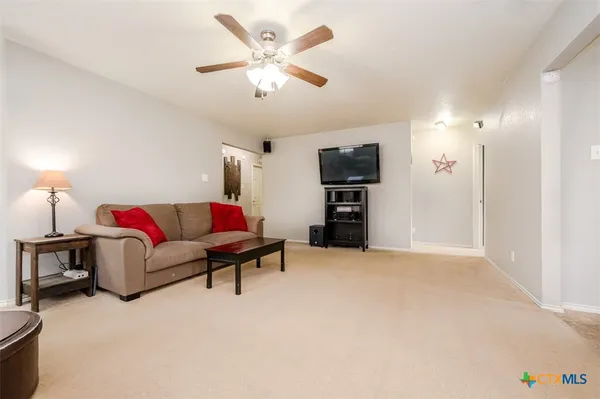 a living room with furniture and a kitchen
