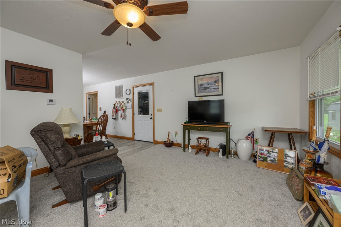 9427 Stonecreek Road Southwest Newcomerstown, OH 43832 - Photo 16 of 29 Living area featuring light gray carpeting and white painted walls