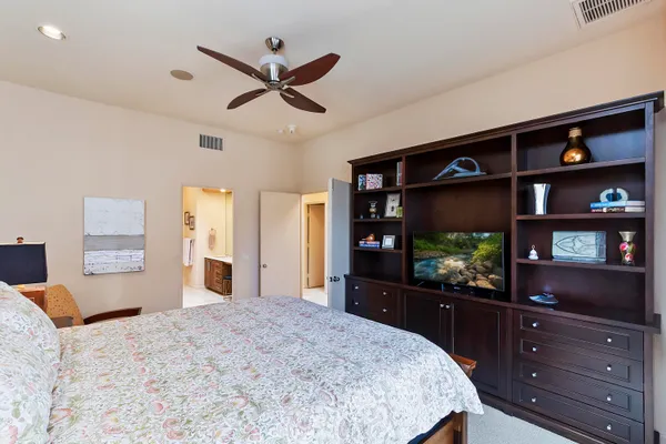 a bedroom with a bed and a flat screen tv