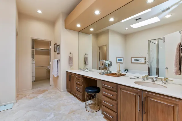 a spacious bathroom with a double vanity sink double and mirror