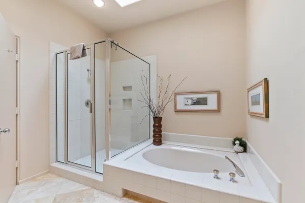 a bathroom with a bathtub and a shower