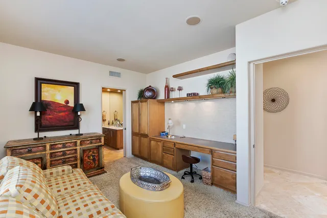 a room with furniture a flat screen tv and a window