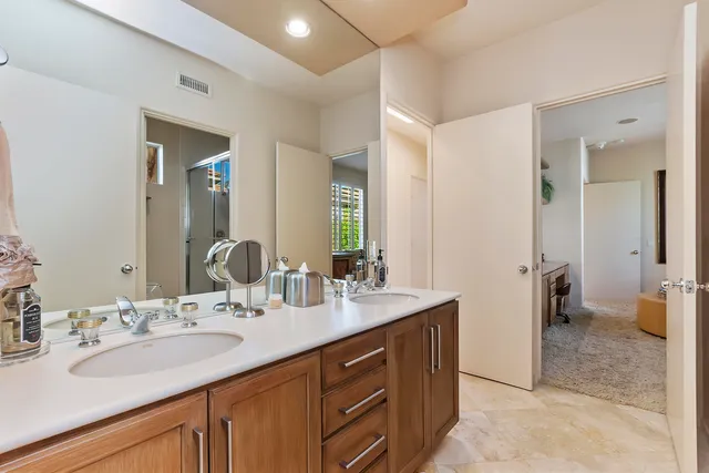 a bathroom with a sink double vanity and a mirror