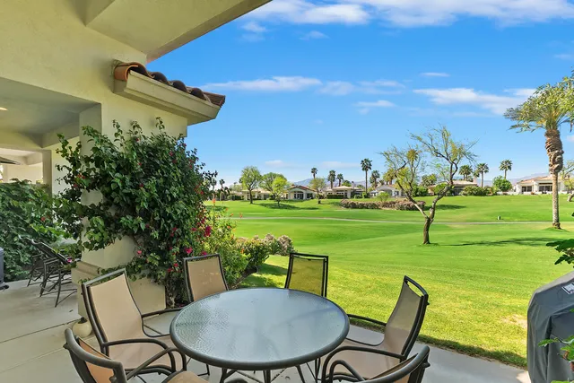 a view of a lake with a table and chairs