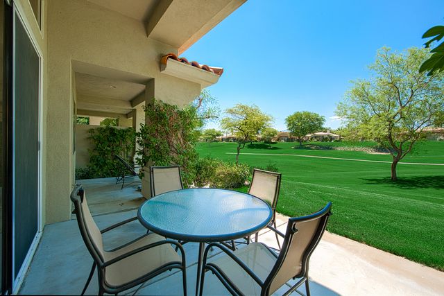 a view of a porch with a table chairs and a table