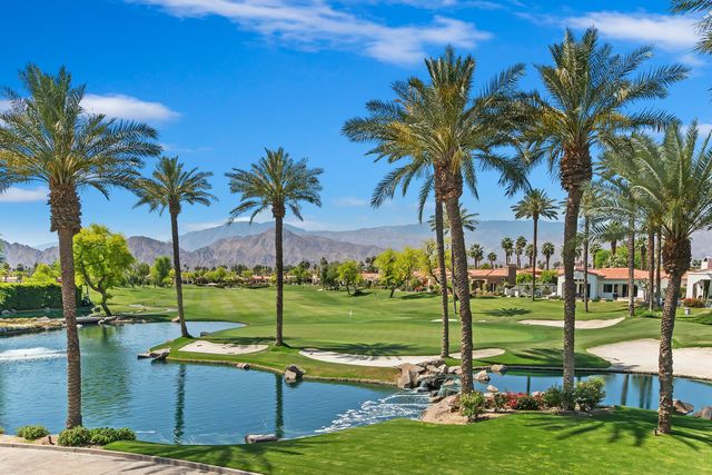 a dining room with furniture and a large window