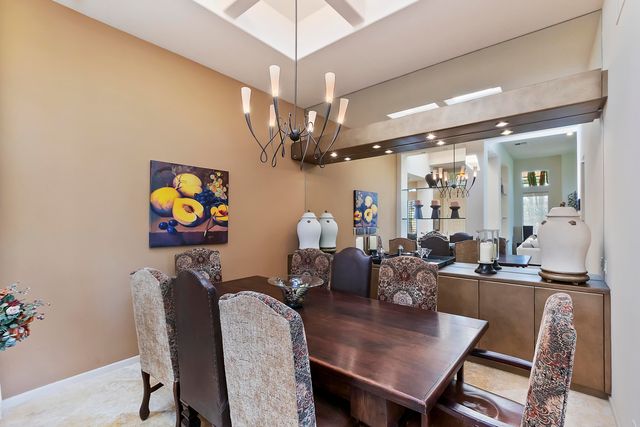 a view of a dining room with furniture and a chandelier