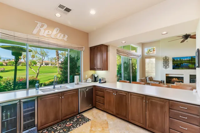 a large kitchen with a large window and cabinets