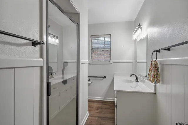 a bathroom with a sink a toilet and shower