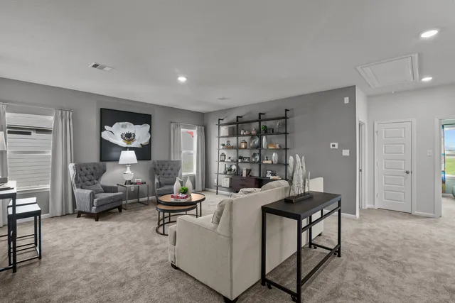 a living room with furniture and a book shelf