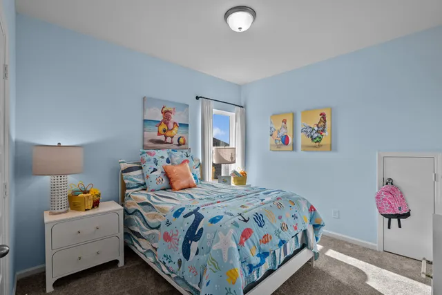 a bedroom with a bed and lamp