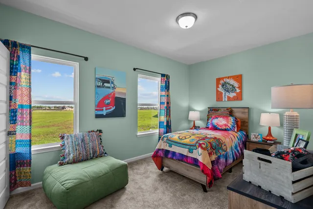 a bedroom with a bed and a painting on the wall