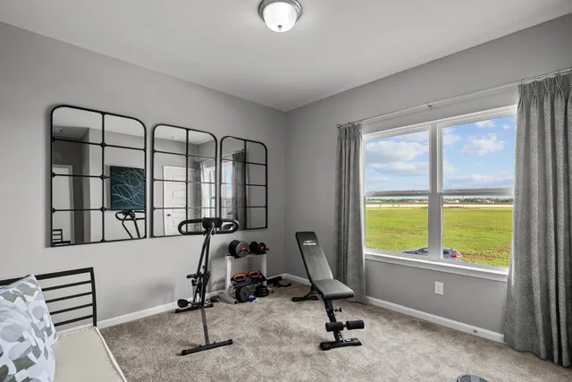 a view of a room with gym equipment and windows