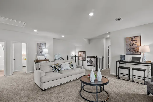 a living room with furniture and a large mirror