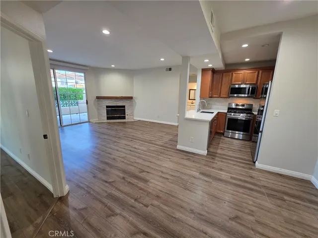 a view of kitchen and hall with wooden floor