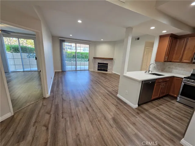 a view of kitchen with cabinets and wooden floor