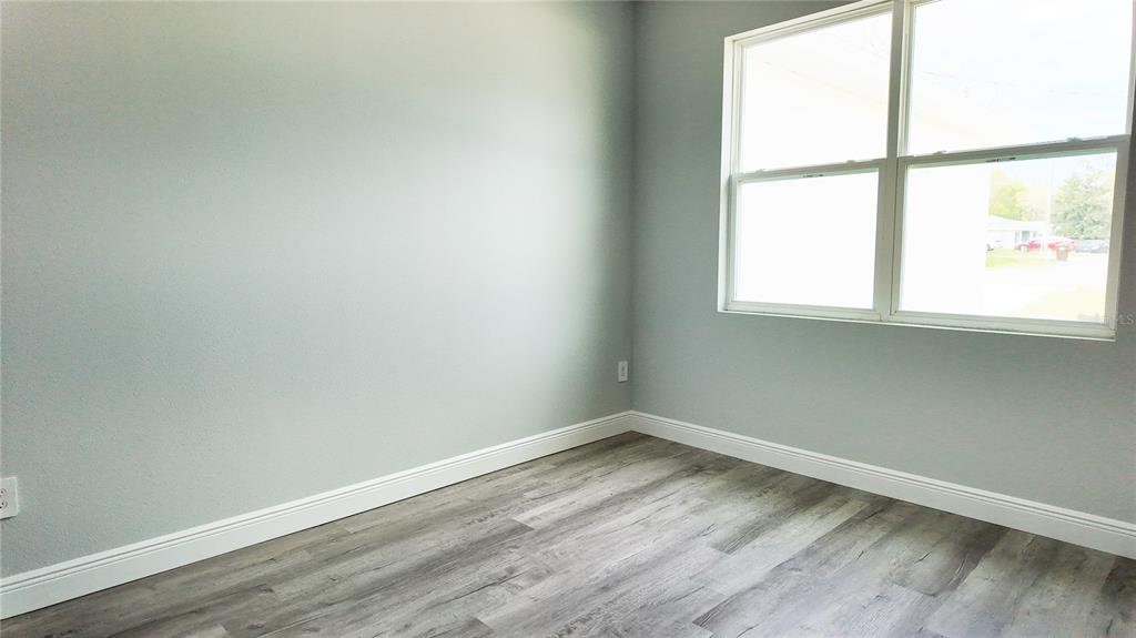7 Spring Pass Ocala, FL 34472 - Photo 32 of 35 an empty room with wooden floor and a window