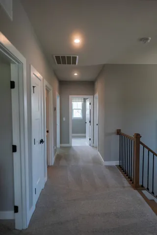 a bedroom with a bed and a lamp