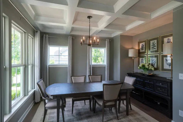 a view of a dining room with a table and chairs