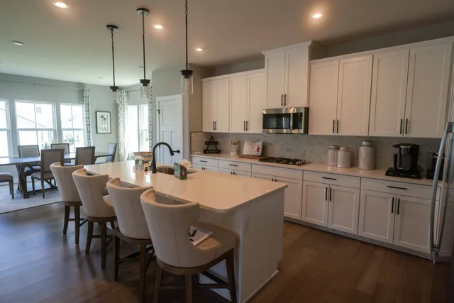 a kitchen with stainless steel appliances a sink a stove and a wooden floors