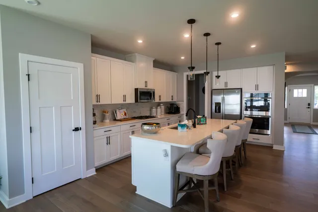 a kitchen with granite countertop a refrigerator and a stove