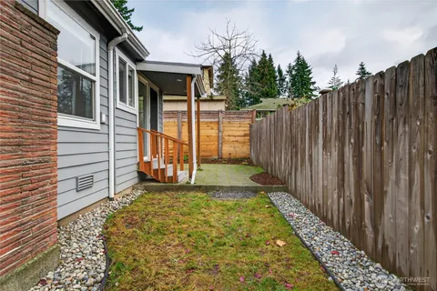 a view of a backyard with wooden fence