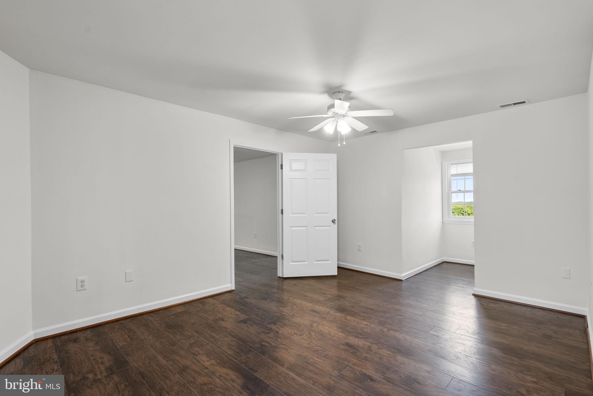 24000 Clarksburg Road Clarksburg, MD 20871 - Photo 21 of 60 an empty room with wooden floor and window
