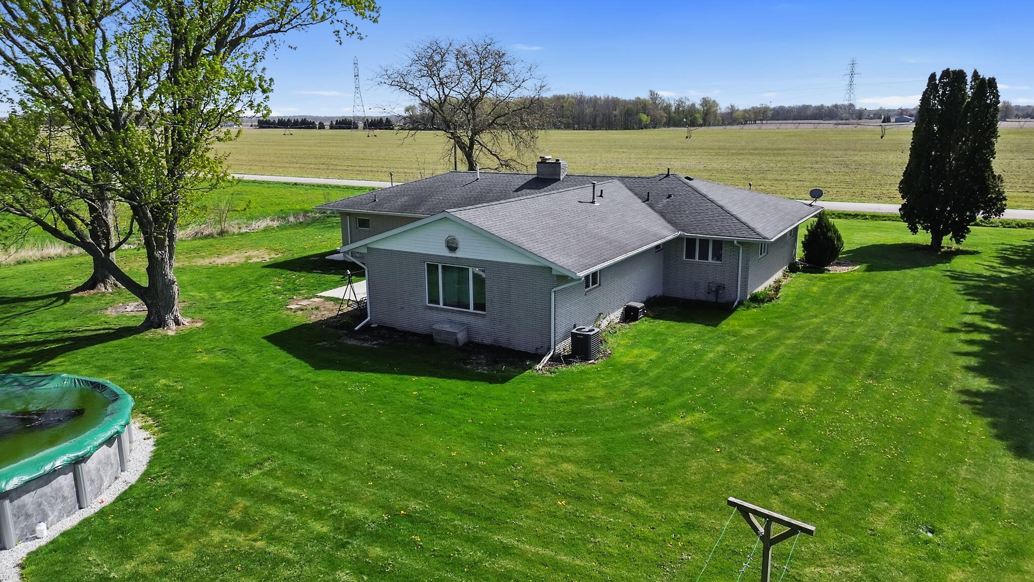 56915 Tulip Road New Carlisle, IN 46552 - Photo 11 of 19 a aerial view of a house with big yard and large trees