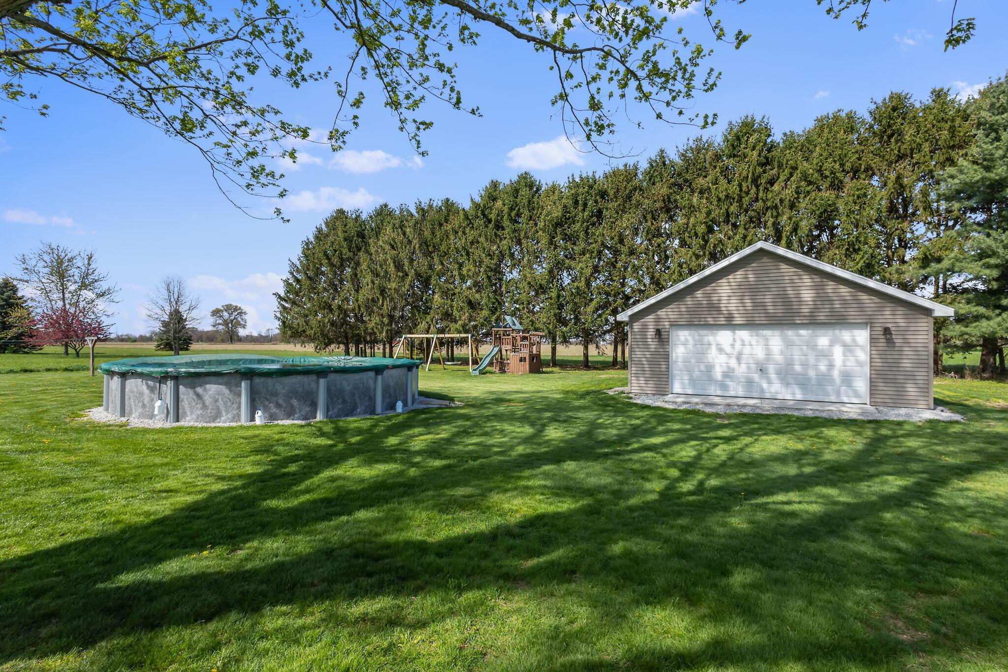 56915 Tulip Road New Carlisle, IN 46552 - Photo 17 of 19 a view of a house with a yard and a bench