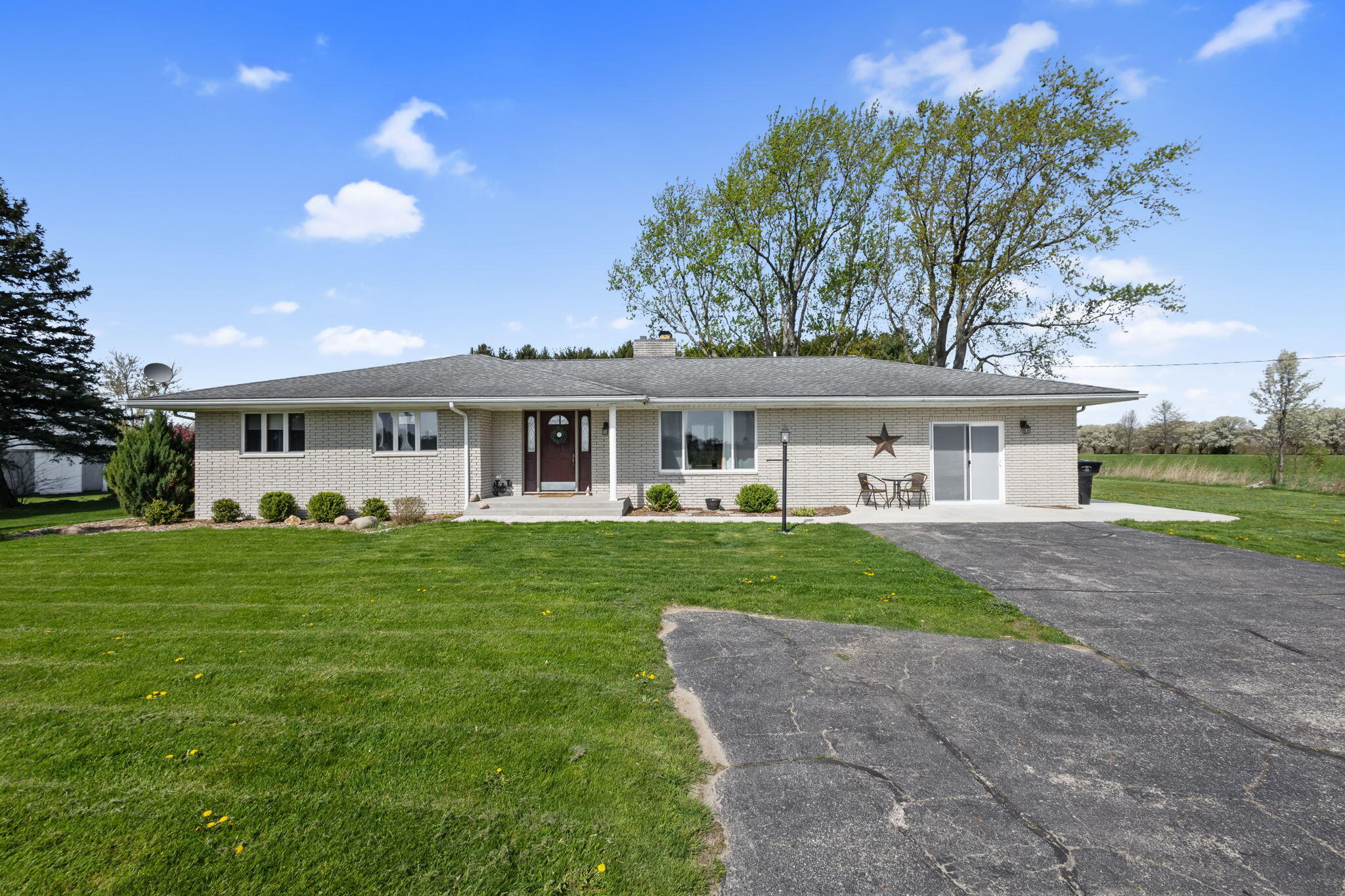 56915 Tulip Road New Carlisle, IN 46552 - Photo 19 of 19 a front view of a house with a garden and yard
