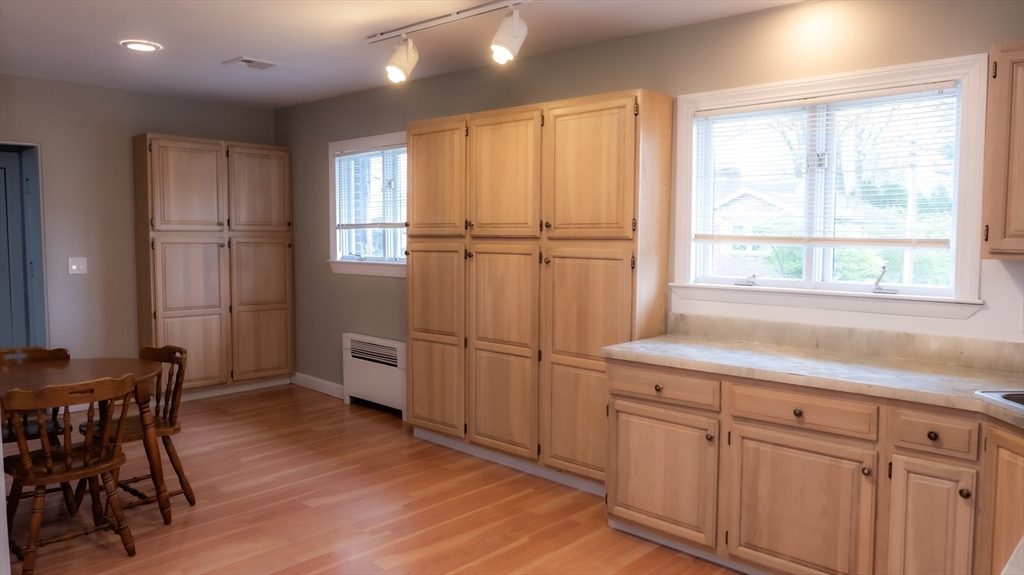 25 Fraser Road Framingham, MA 01702 - Photo 3 of 21 a kitchen with a refrigerator a table and chairs