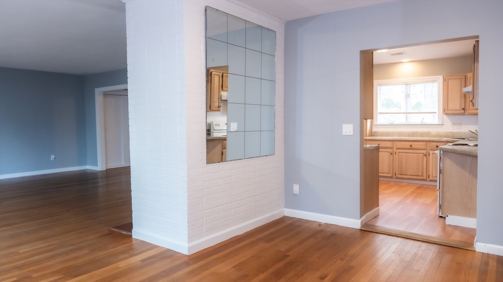 25 Fraser Road Framingham, MA 01702 - Photo 6 of 21 an empty room with wooden floor & cabinet