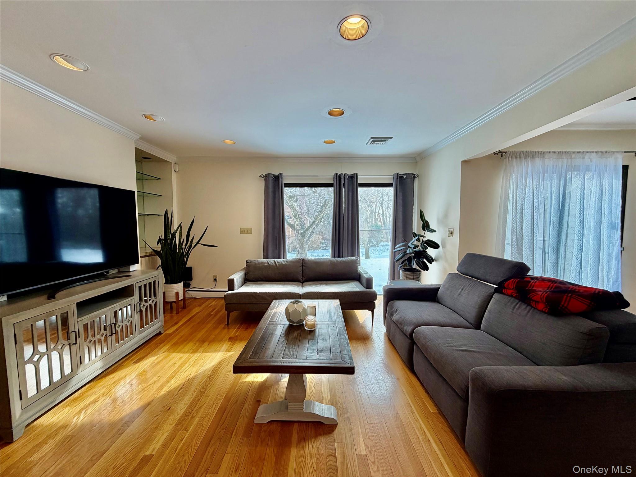 75 Greenway Close, Unit 1 Rye Brook, NY 10573 - Photo 24 of 24 a living room with furniture and a flat screen tv