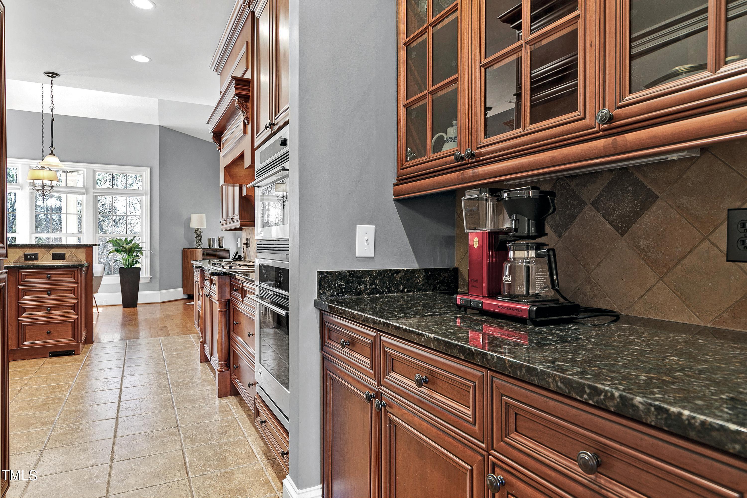 2912 Ryton Court Raleigh, NC 27613 - Photo 11 of 86 a kitchen with stainless steel appliances granite countertop a stove and cabinets