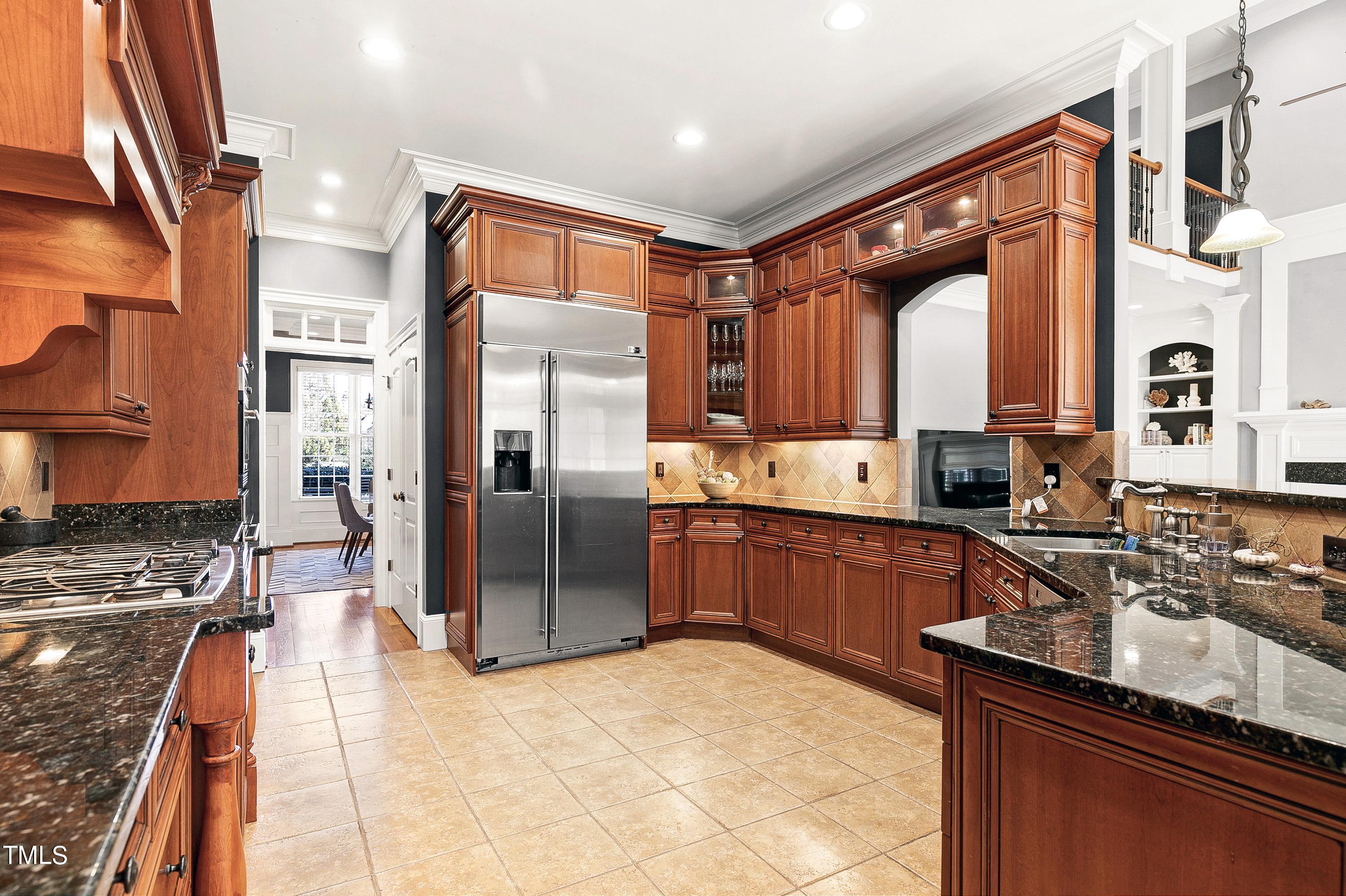 2912 Ryton Court Raleigh, NC 27613 - Photo 23 of 86 a large kitchen with stainless steel appliances granite countertop a refrigerator a stove and a sink