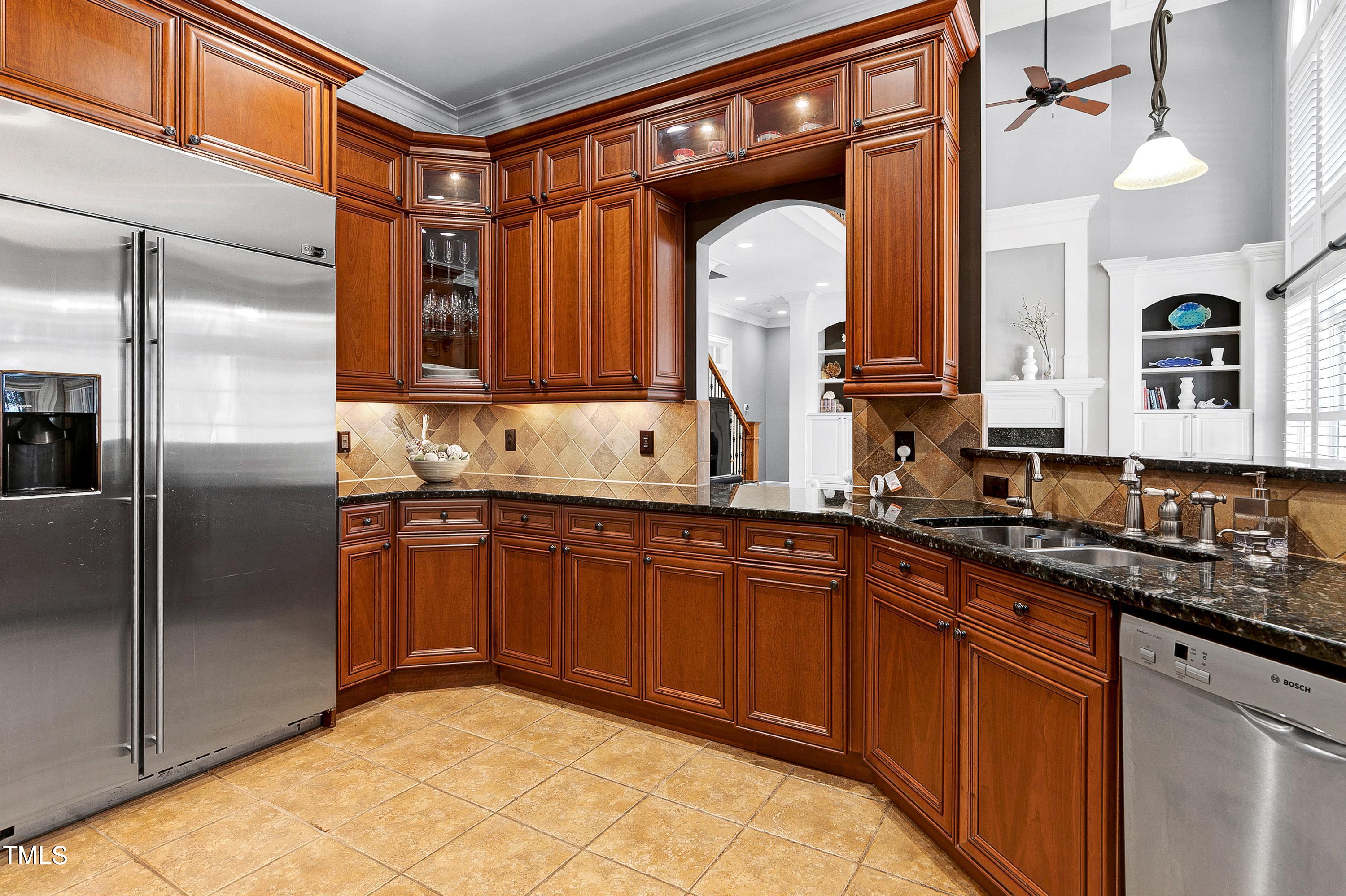 2912 Ryton Court Raleigh, NC 27613 - Photo 24 of 86 a kitchen with stainless steel appliances granite countertop a sink and a refrigerator