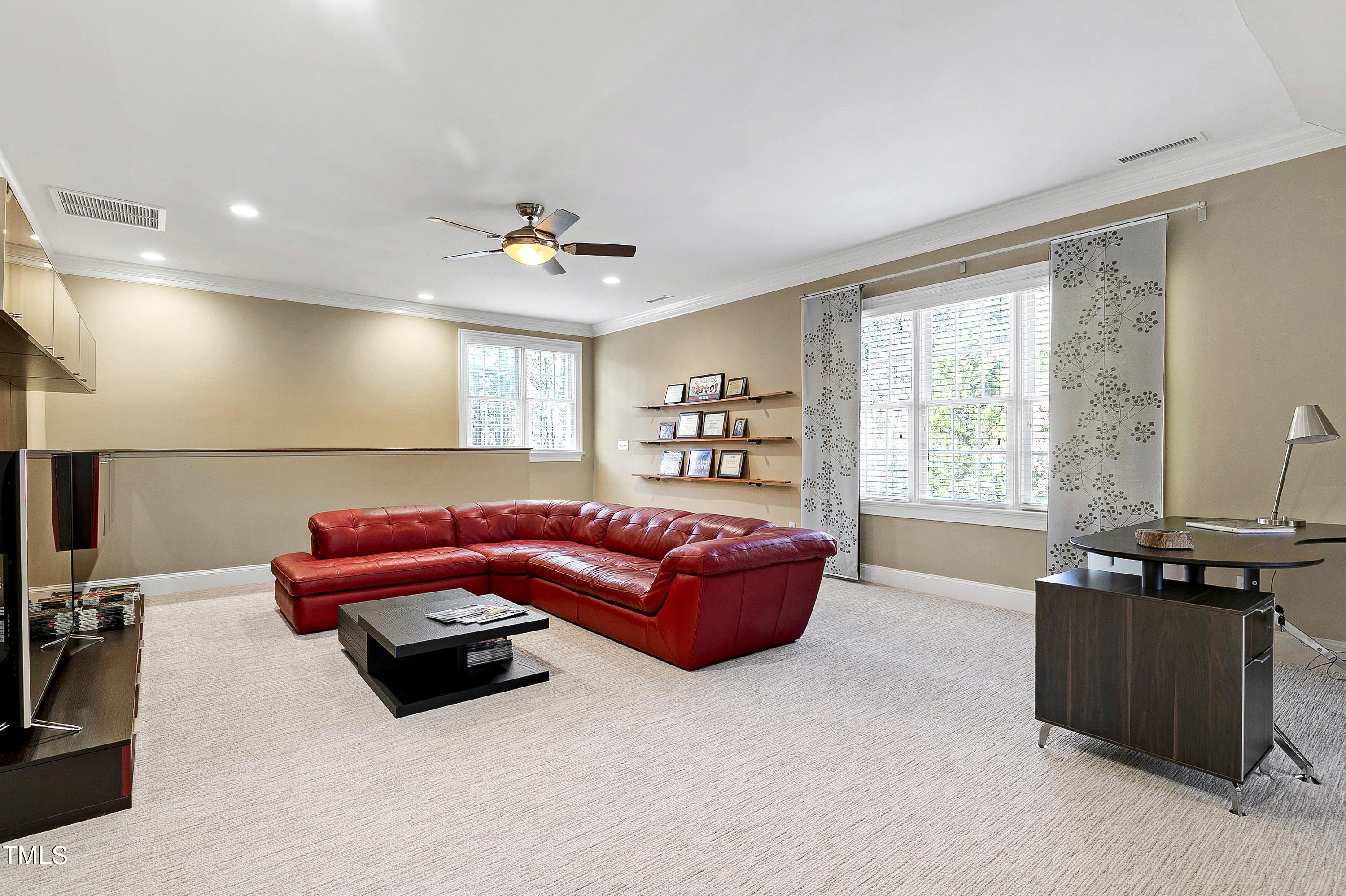 2912 Ryton Court Raleigh, NC 27613 - Photo 45 of 86 a living room with furniture a ceiling fan and a window