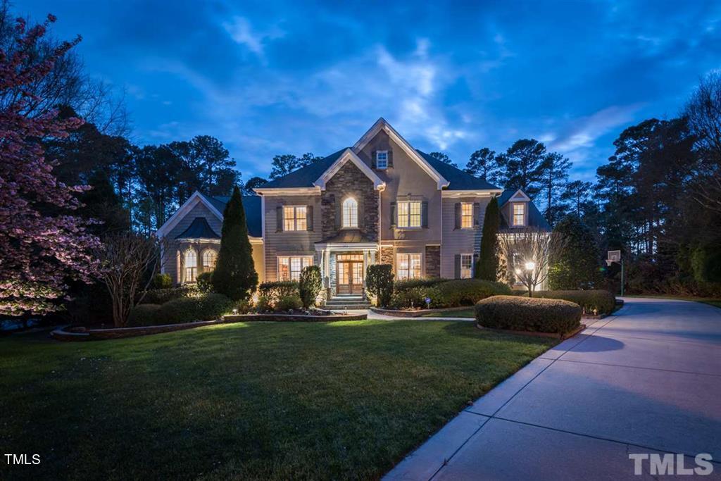 2912 Ryton Court Raleigh, NC 27613 - Photo 5 of 86 a front view of a house with a garden and trees