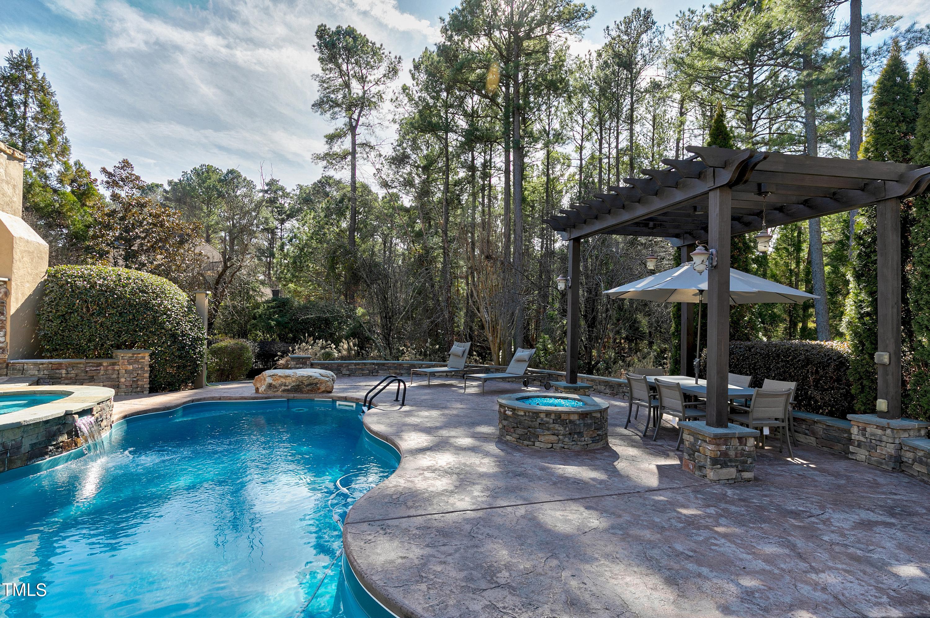 2912 Ryton Court Raleigh, NC 27613 - Photo 71 of 86 a view of a patio with table and chairs under an umbrella with large trees