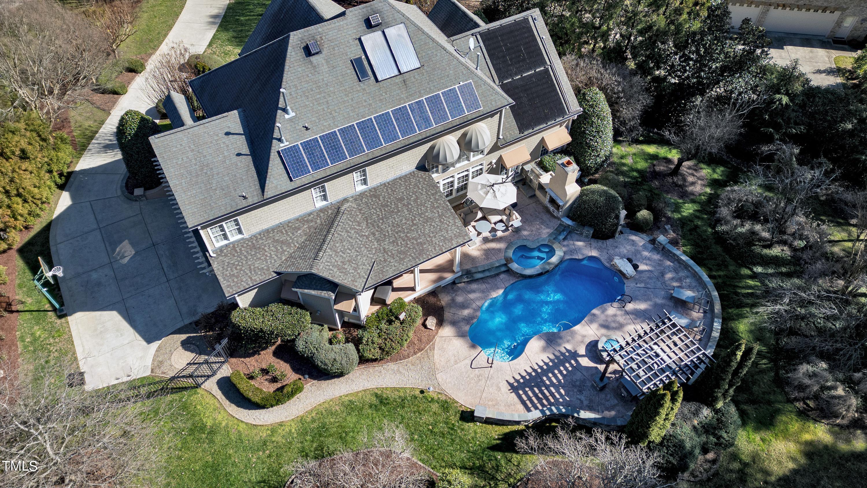 2912 Ryton Court Raleigh, NC 27613 - Photo 86 of 86 an aerial view of a house with patio chairs and a fire pit