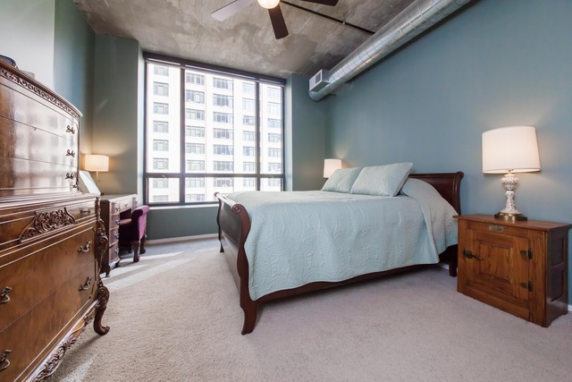 520 South State Street, Unit 501 Chicago, IL 60605 - Photo 14 of 25 a bedroom with a bed and a couch
