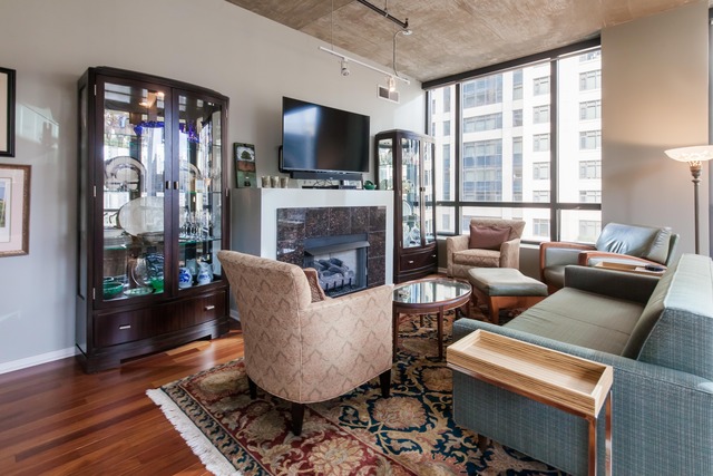 520 South State Street, Unit 501 Chicago, IL 60605 - Photo 5 of 25 a living room with furniture a flat screen tv and a fireplace