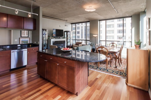 520 South State Street, Unit 501 Chicago, IL 60605 - Photo 10 of 25 a large kitchen with stainless steel appliances granite countertop a stove and a wooden floors
