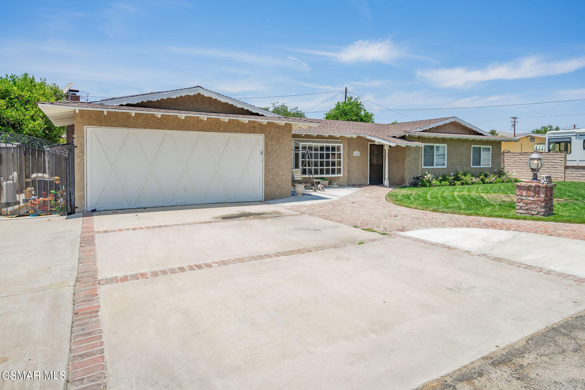 4198 Adam Road Simi Valley, CA 93063 - Photo 6 of 19 a front view of a house with a yard and garage