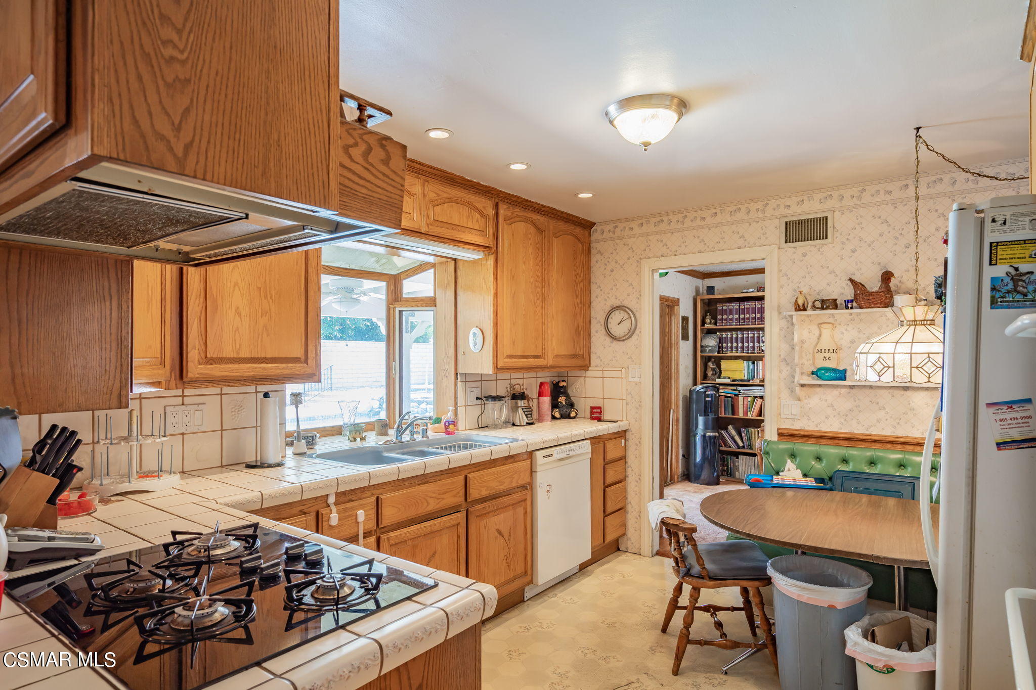 4198 Adam Road Simi Valley, CA 93063 - Photo 9 of 19 a kitchen with a sink a stove and a refrigerator