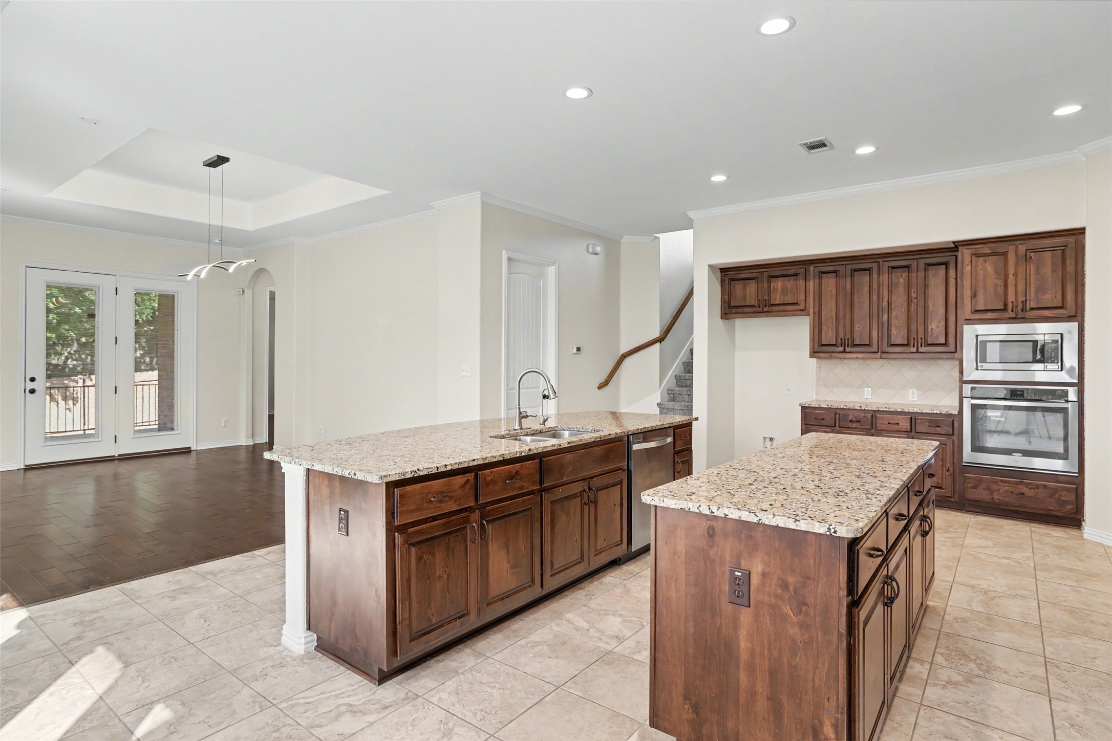1020 Winding Way Drive Georgetown, TX 78628 - Photo 32 of 32 Kitchen with a kitchen island with sink, light stone countertops, stainless steel appliances, arched walkways, and open floor plan