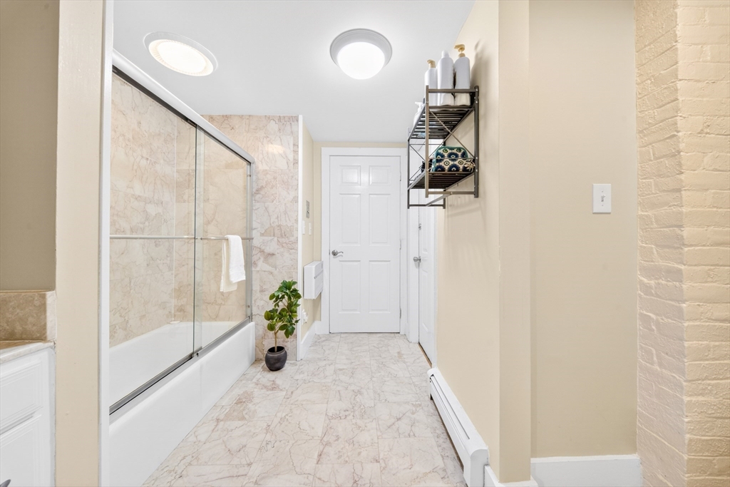352 Tappan Street, Unit 1 Brookline, MA 02445 - Photo 21 of 42 a view of a bathroom with a shower and mirror