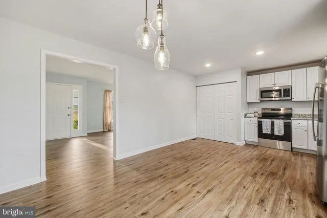 a view of kitchen with sink and wooden floor