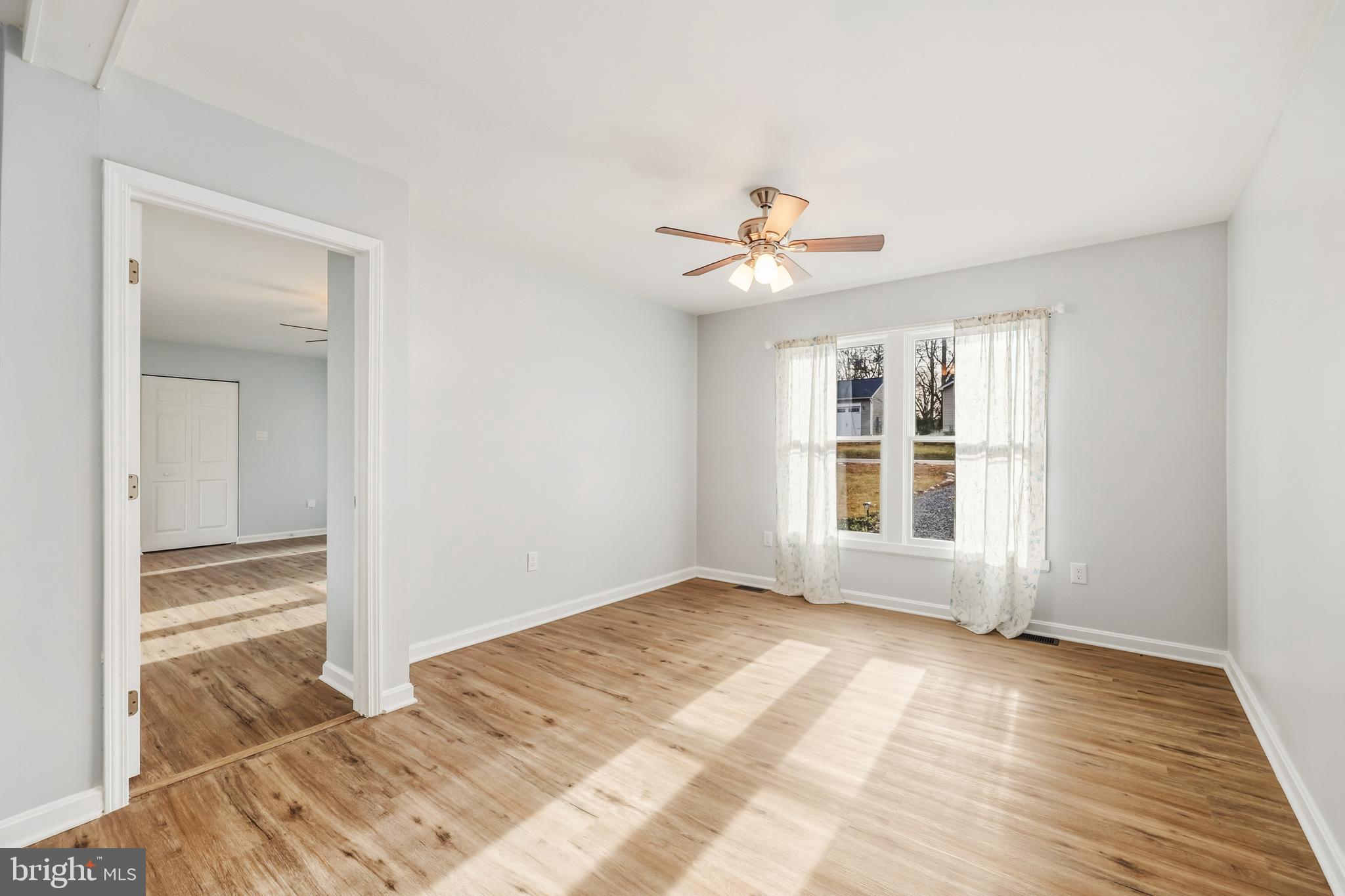 207 Spotswood Road Locust Grove, VA 22508 - Photo 13 of 58 a view of an empty room with a window and wooden floor