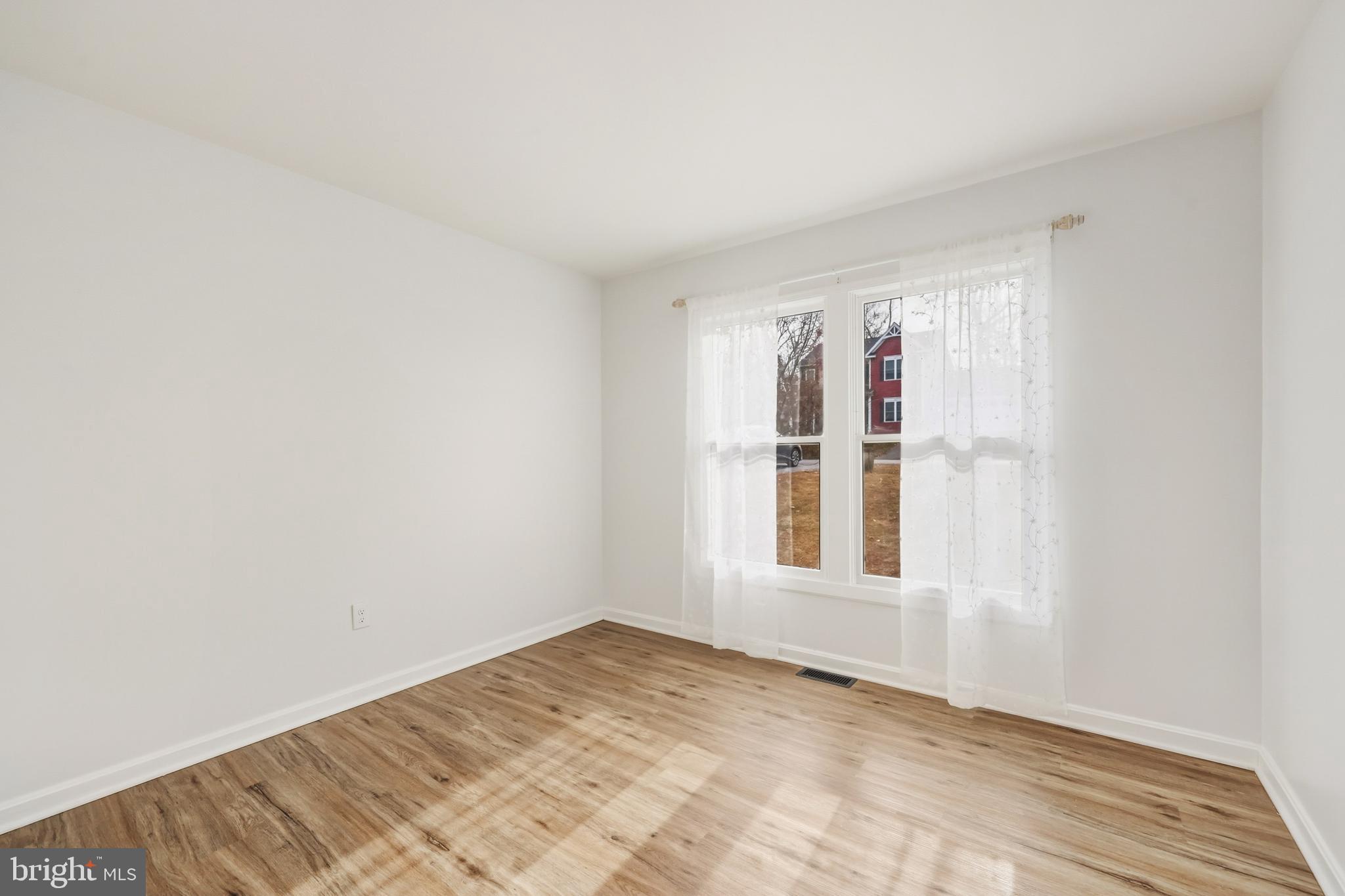 207 Spotswood Road Locust Grove, VA 22508 - Photo 19 of 58 a view of an empty room with wooden floor and a window